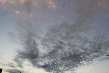 Fototapeta premium White bright clouds in a light blue sky. Beautiful sky