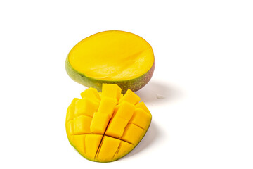 A slice of yellow mango with a green stem. The slice is cut in half. The other half is not shown