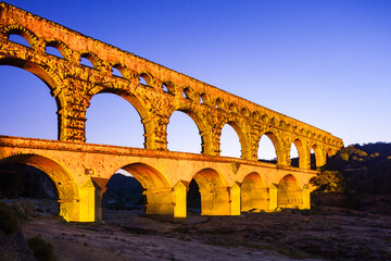 Pont du Gard, ancient Roman aqueduct bridge, colorful projection mapping video show, under Provence starry night sky, Gorges du Gardon, natural landscape designated Biosphere Reserve by UNESCO, France