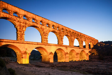 Pont du Gard, ancient Roman aqueduct bridge, colorful projection mapping video show, under Provence starry night sky, Gorges du Gardon, natural landscape designated Biosphere Reserve by UNESCO, France