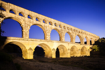 Pont du Gard, ancient Roman aqueduct bridge, colorful projection mapping video show, under Provence starry night sky, Gorges du Gardon, natural landscape designated Biosphere Reserve by UNESCO, France