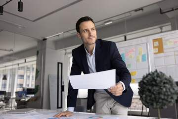 Positive successful Hispanic businessman thinking on startup project, marketing sales research,...