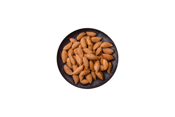 Roasted or raw almond nuts in shell in bowl