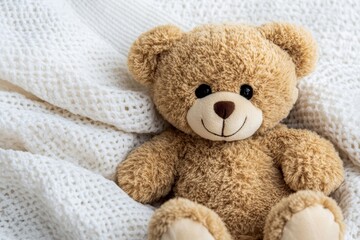 Obraz premium Adorable Teddy Bear on Knit Blanket - Cute teddy bear resting on a soft, white knit blanket. Perfect for children's products, websites, and blogs