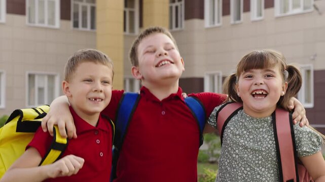 Happy schoolchildren backpacks, cheerful kids school uniforms, smiling students front school, group friends enjoying school time, excited children first day school, laughing kids posing photo, best