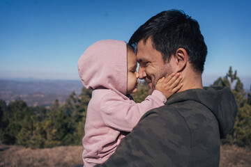Father and Daughter Sharing a Loving Moment in Nature