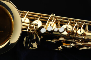 Obraz premium Jazz. One beautiful saxophone on black background, closeup