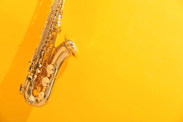 Golden saxophone on yellow background. Space for text