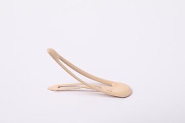 One beige hair clip on white background
