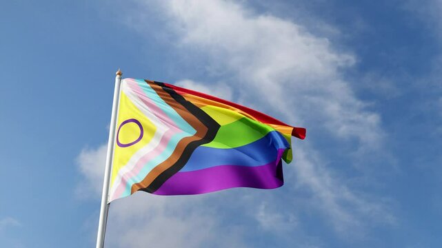 progress and intersex pride flag waving in the wind on a blue sky, lgbt flag, gay pride symbol, lgbtqia+ tall flagpole, lgbtqia, queer, realistic flag, symbol of the gay pride, tolerance, love	
