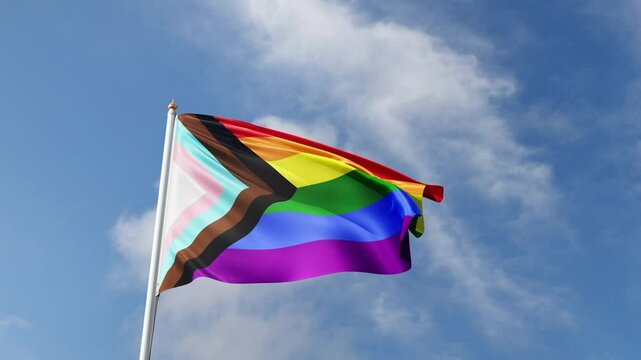 progress pride flag waving in the wind on a blue sky, new pride flag, lgbt flag, gay pride symbol, lgbtqia+ tall flagpole, lgbtqia, queer, realistic flag, symbol of the gay pride, tolerance, love	
