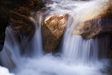 long exposure photography of flowing water from a mountain creek at a spring day