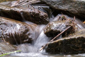 long exposure photography of flowing water from a mountain creek at a spring day
