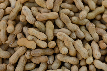 Peanuts arranged beautifully for sale at a vibrant local market during a sunny afternoon