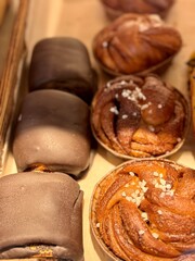 An Assortment of Delicious Pastries Beautifully Displayed in a Charming Bakery Shop. An assortment of delicious mouthwatering pastries that showcase both chocolatecovered and cinnamon options