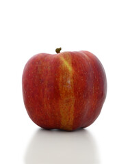Juicy red apple displaying vibrant colors against a minimalist white backdrop