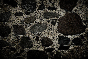 texture of concrete wall with rough granite boulders