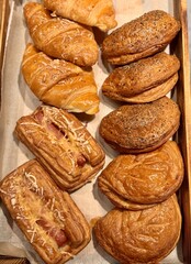 Indulge in the exquisite taste of our Delicious Croissants and Gourmet Pastries, Baked Daily. A tempting selection of freshly baked golden croissants and pastries, perfect for any bakery display