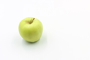 A common green apple on white background.