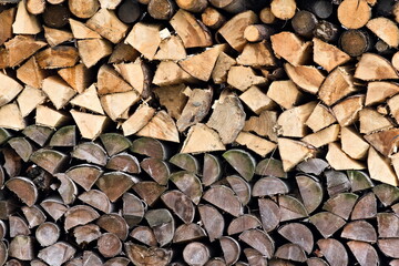 Two colored pile of stacked firewood. Natural background.