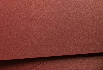 Fototapeta premium Burgundy paper background with a smooth texture and subtle shimmer. Warm, rich tones create an elegant, luxurious design, perfect for premium stationery and artistic compositions with a minimalistic,.