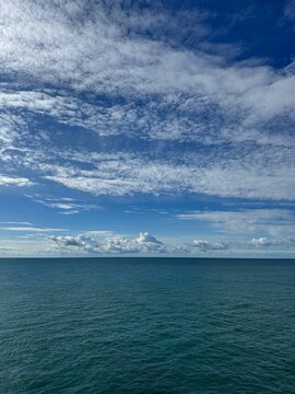Beautiful cloudy sky over calm blue sea