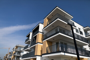 This apartment complex has stylish balconies that enhance the blue skys elegance