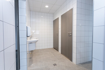 A Contemporary Public Restroom Featuring a Stylish and Modern Design with Clean Aesthetics