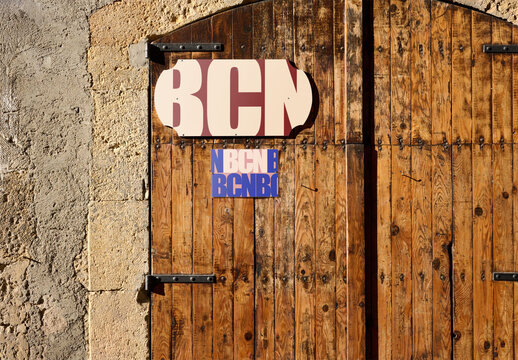 Urban Retail Business Sign Mockup on Wooden Door in Barcelona