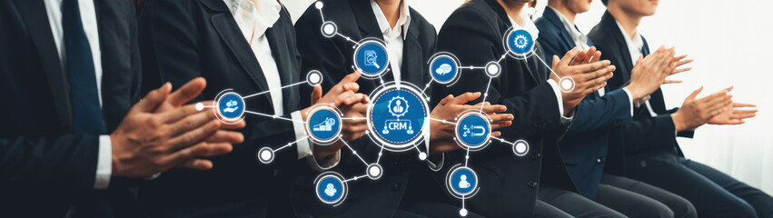 Business professionals engaged in a presentation on customer relationship management with various technology icons representing connectivity and collaboration. Amity