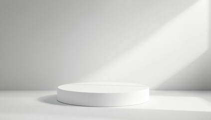 Clean, minimalist, white round pedestal on a white background. Sunlight casts shadows