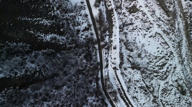 A road in a mountainous area. Talgar gorge. Tien Shan Mountains, Ile-Alatau Nature Park. Mountainous area with different vegetation. The view from the drone.