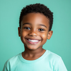 Naklejka premium The joyful Afro American boy, around 8-10 years old, smiles brightly against a colorful background, ideal for modern advertising and promotional content