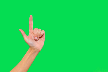 Hand gesture indicating the number one against a bright green background in a well-lit setting