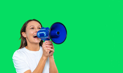 Obraz premium Person holding a megaphone enthusiastically speaking against a bright green backdrop during an outdoor event or rally