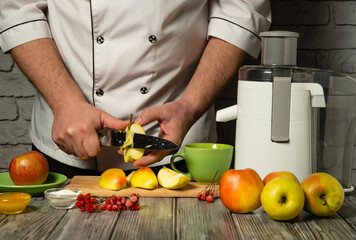 A chef skillfully peels and slices vibrant apples on a wooden cutting board as a juicer stands nearby. The countertop is adorned with colorful fruit, creating a lively atmosphere