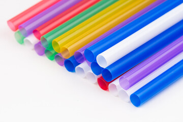 Colorful plastic straws for drinks. Abstract background of blue, green, red and yellow lines.