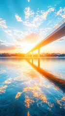 Fototapeta premium Bridge structure bathed in golden hour glow over reflective water low angle view architectural photography