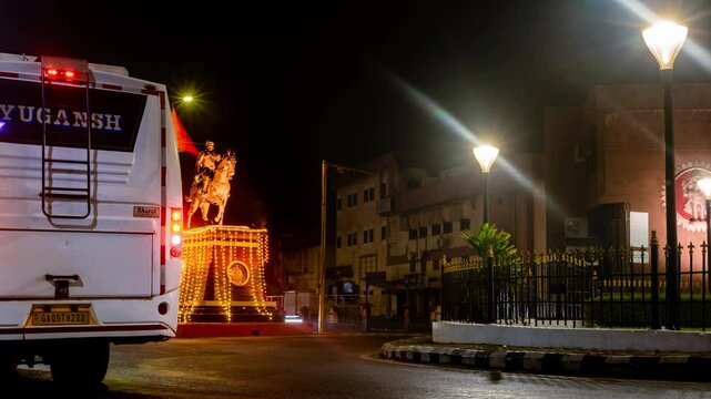 4k Hyperapse Timelapse Night footage of Mapusa City in Goa with traffic light trails of vehicles and statue of Shivaji Maharaj