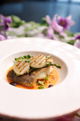 Beautifully plated fish dish served in a restaurant. Gourmet seafood cuisine with elegant presentation.
