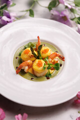 Shrimp soup with herbs and vegetables, served in a bowl. Fresh seafood cuisine with aromatic broth.