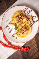 Sweet pancakes with caramelized apples and sauce, served as a delicious dessert.