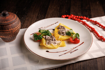 Savory pancakes filled with mushrooms and sour cream, served hot in a rustic restaurant style.