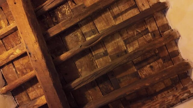 A close-up of the aged wooden ceiling inside Christopher Columbus&rsquo; house in Genoa, Italy. The rustic wooden beams and handcrafted structure reflect the medieval architecture of the explorer&rsquo;s time.