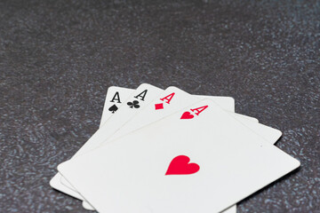 Deck of playing cards, with the top card showing the Ace of heart. The cards are stacked on top of each other