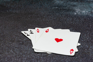 Deck of playing cards, with the top card showing the Ace of heart. The cards are stacked on top of each other