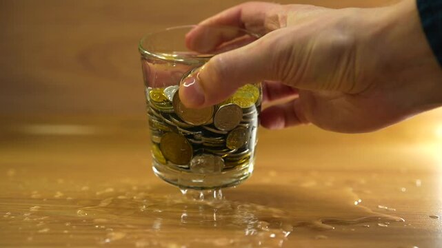 Metal coins in a glass of water.
Kopecks in a glass.
Money in a glass of water.
Pennies in water
