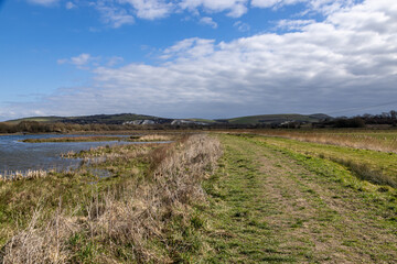 A pathway through wetlands in Lewes in Sussex, on a sunny early spring day © lemanieh