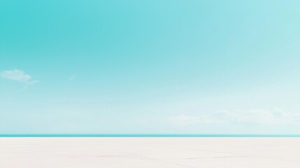 A serene beach scene with a clear blue sky and calm ocean.