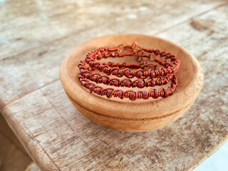 handmade wire copper bracelet on wooden table
